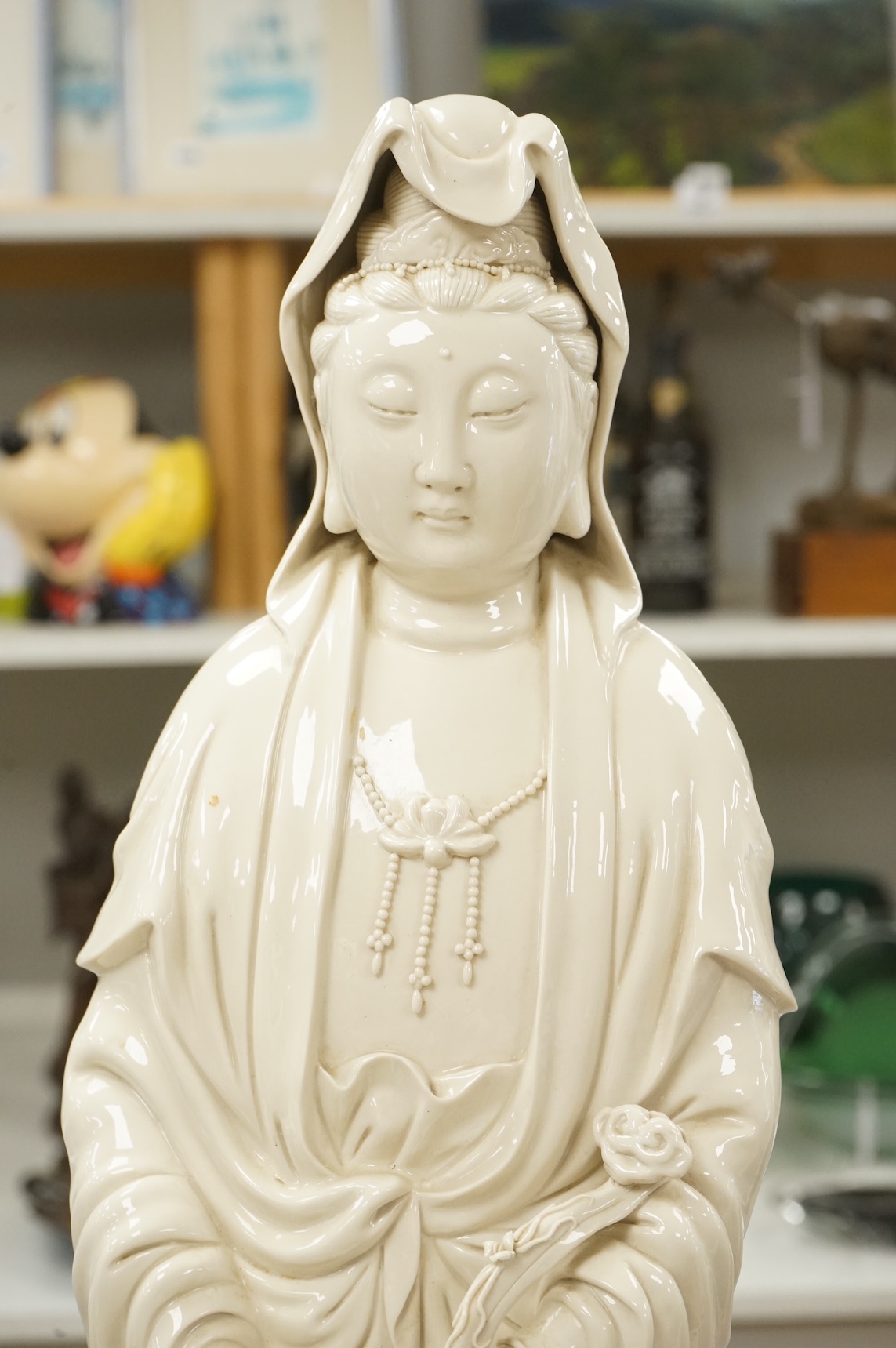 A Chinese blanc de chine figure of Guanyin, on stand, 81cm high